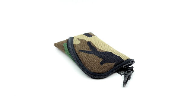 A Mini Ghost Whale Pouch in Beaver Camo (green, brown, tan, and black camoflauge pattern).